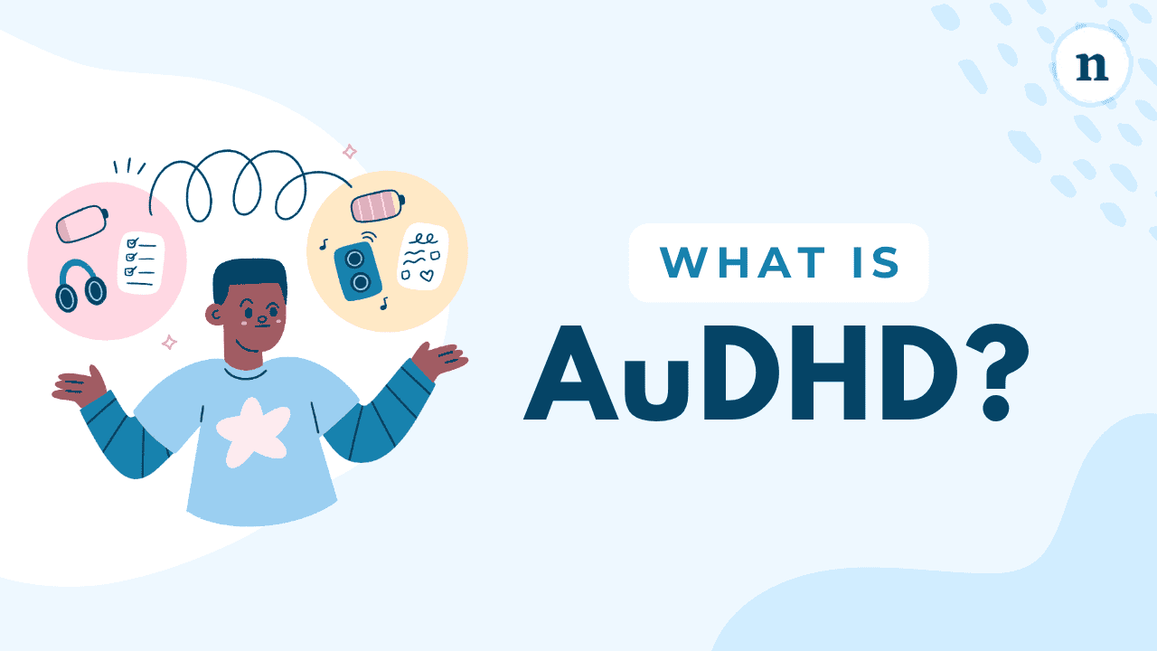 Thumbnail image with the title ‘What Is AuDHD?’ in large dark blue text on a light blue background, showing an illustrated person with arms outstretched, surrounded by floating icons like headphones, a checklist, a battery, and a speaker connected by a swirling line.