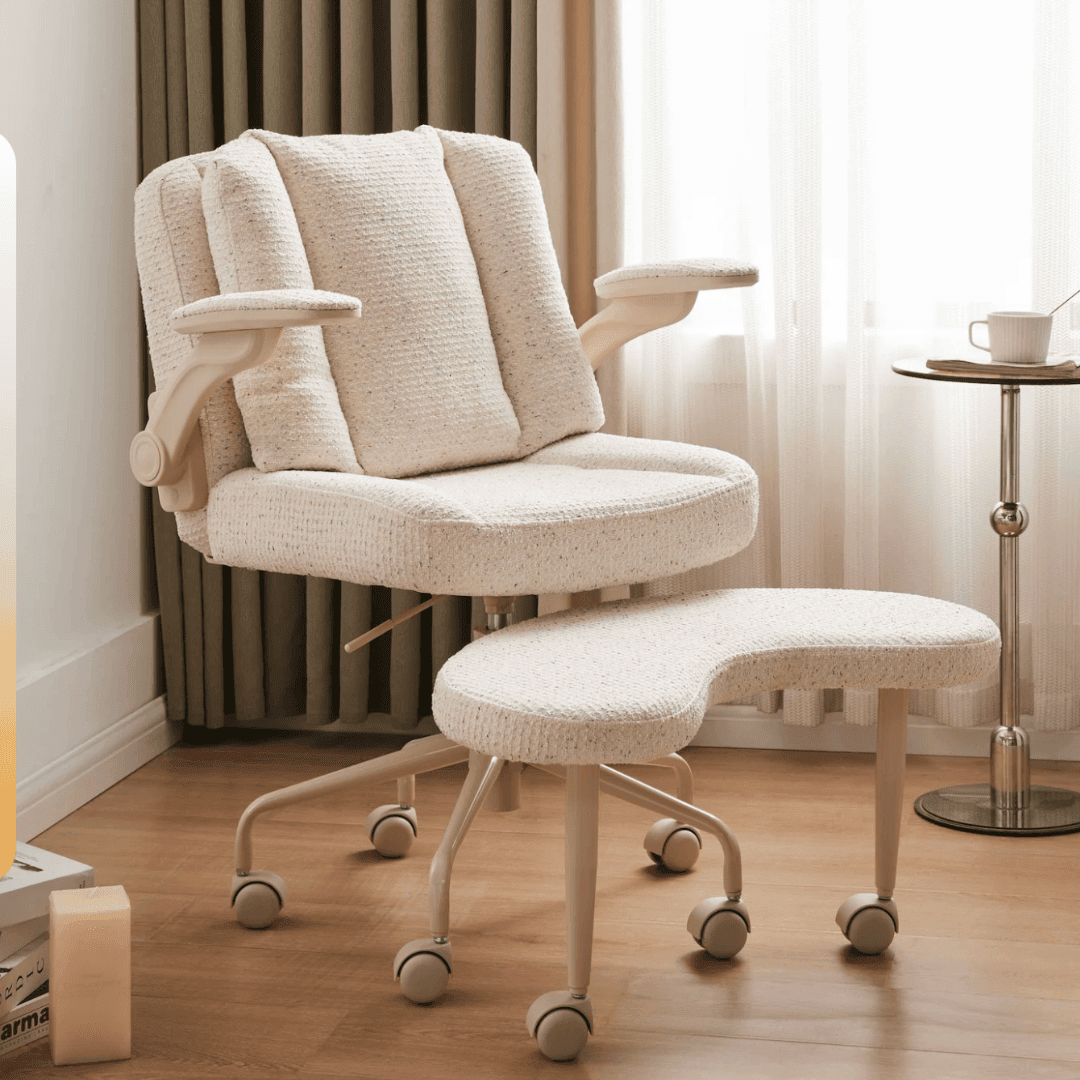 A cream boucle ergonomic office chair with a matching footrest on casters, in a softly lit home office setting, representing the Pipersong chair.